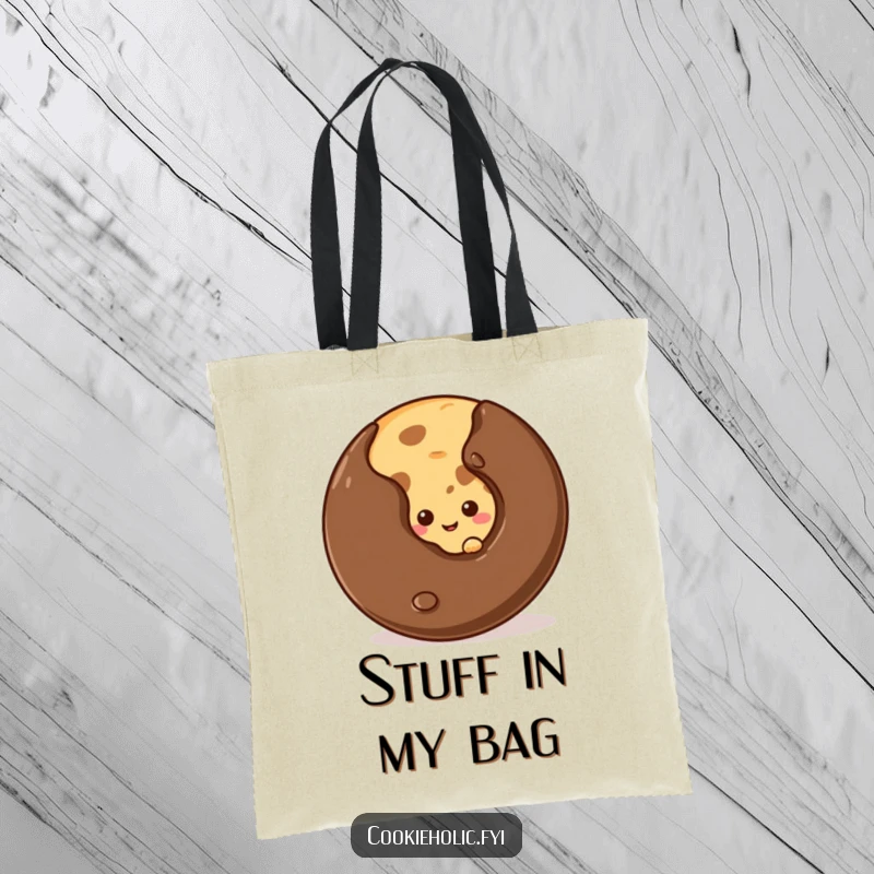 Funny shy cookie tote bag showing a cookie peeking from behind a large chocolate chip, perfect for carrying goodies.